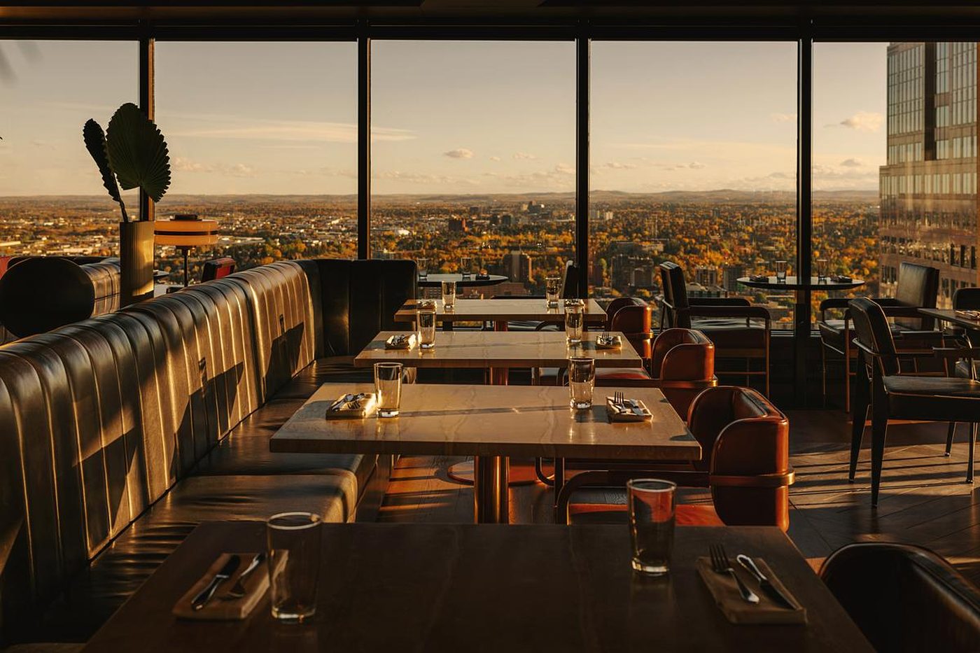 A Calgary restaurant with a city view at sunset