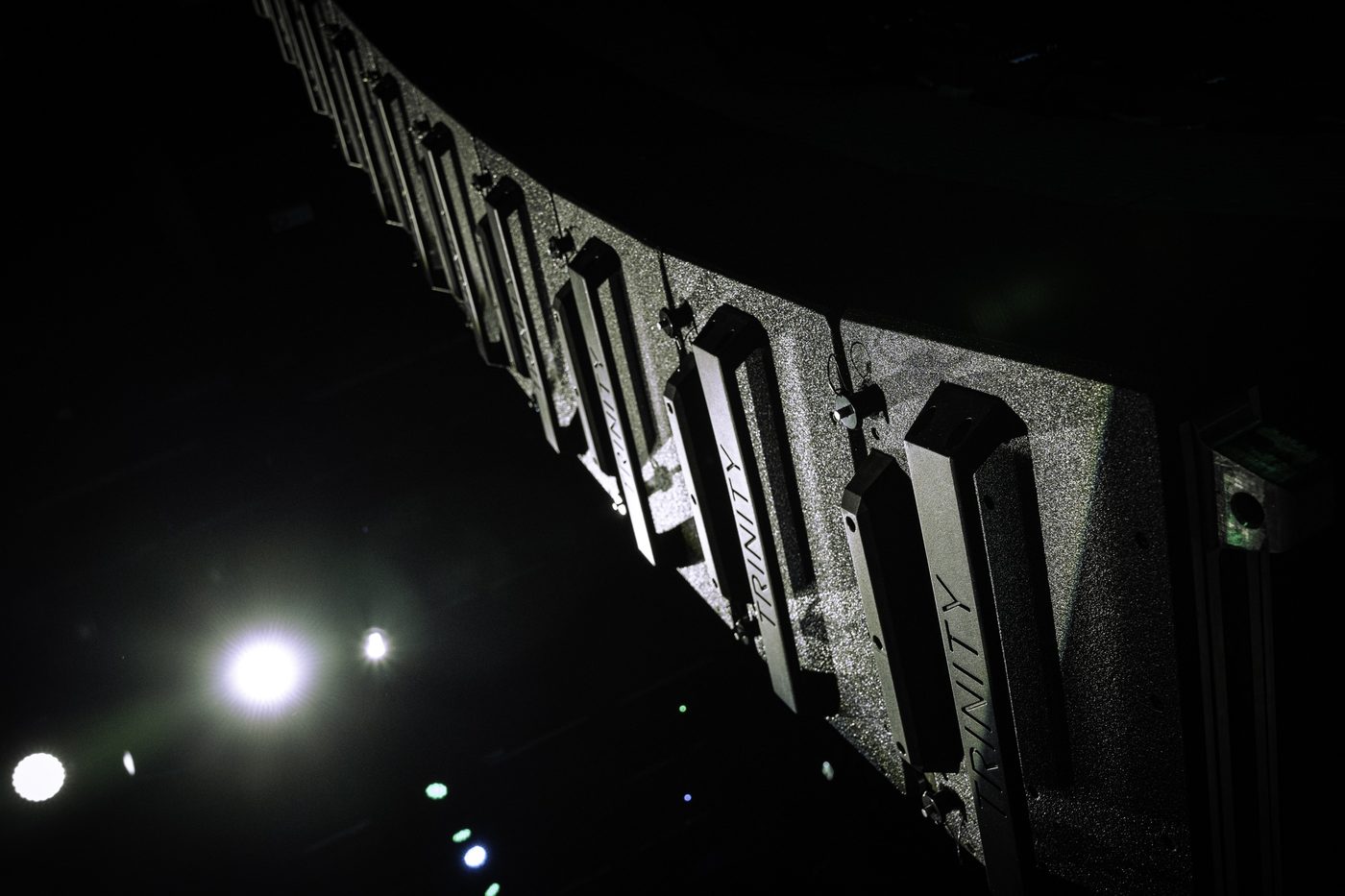 A PK line array in silhouette against show lighting
