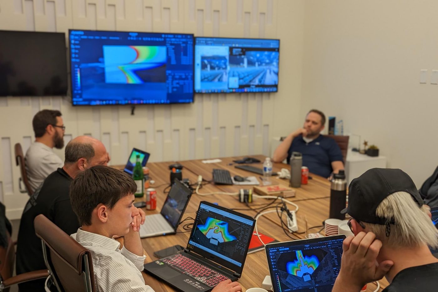 A working session around the table with software on screen