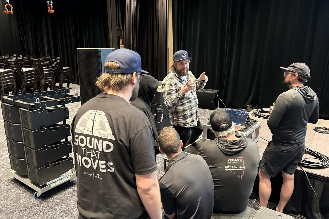 Partners gathered around PK line array modules during training